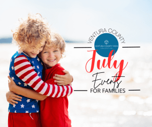Two kids hugging on beach in red, white and blue.