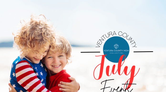 Two kids hugging on beach in red, white and blue.