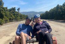 couple riding sunburst rail bikes