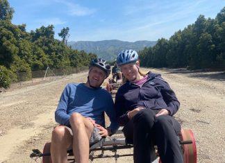 couple riding sunburst rail bikes