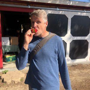 man eating a strawberry