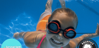 Little girl swimming underwater in a pool