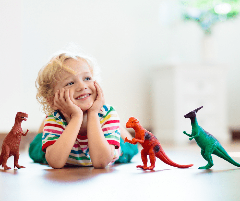 boy playing with dinosaur