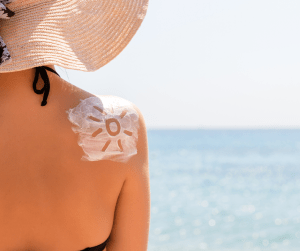 woman in sun with lotion in a sun shape