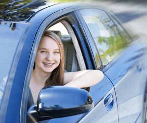 teen driver in a blue car