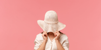 woman hiding beneath her hat