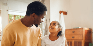 Dad Reading a Book to Daughter