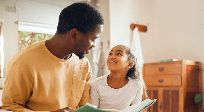 Dad Reading a Book to Daughter