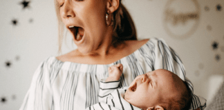 Woman yawning while baby is crying