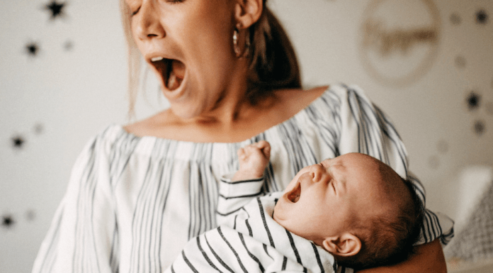 Woman yawning while baby is crying
