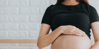 pregnant woman touching belly