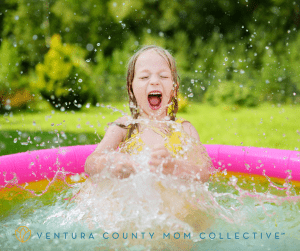 Little girl splashing in pool