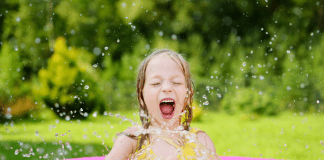 Little girl splashing in pool