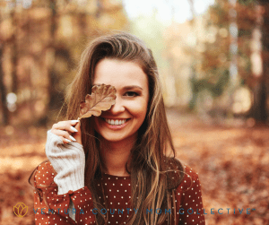 Smiling Woman Covering Her Eye with a Leaf