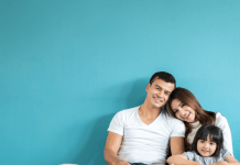 Portrait happy Asian family over blue background