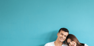 Portrait happy Asian family over blue background